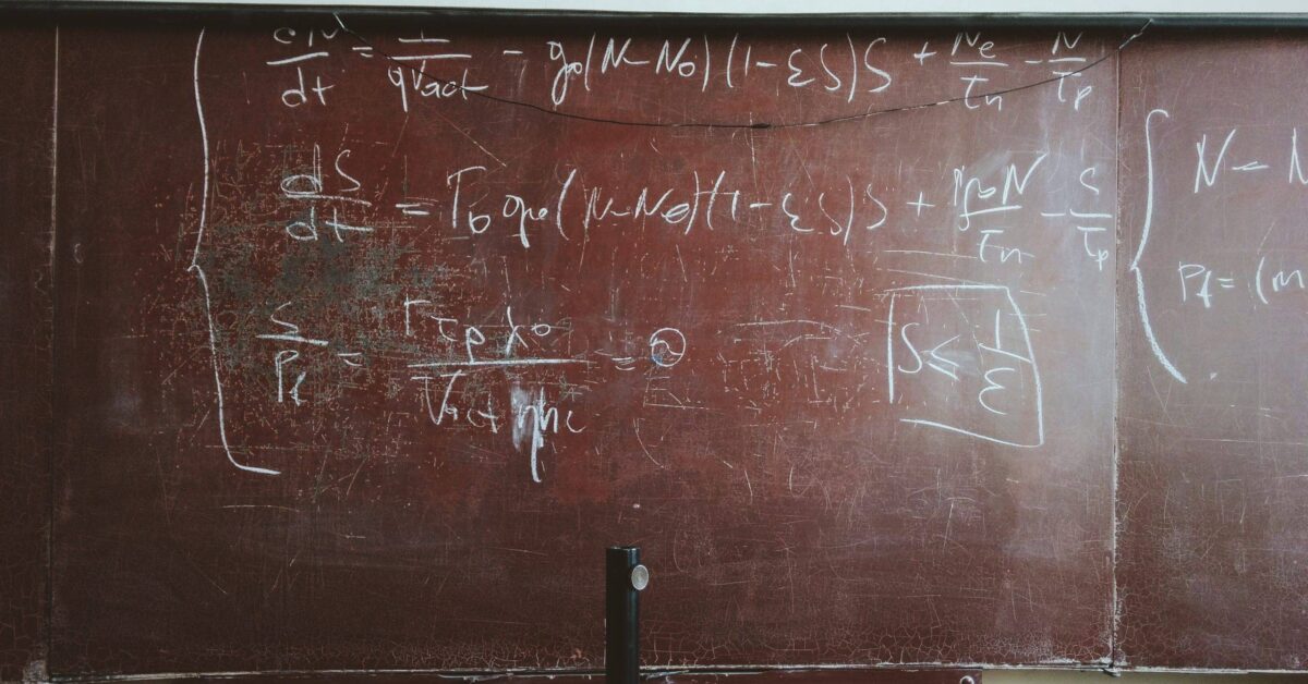 written equations on brown wooden board