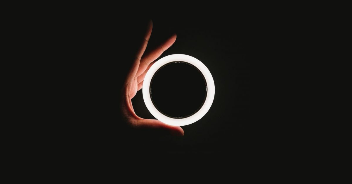 person holding white ring light