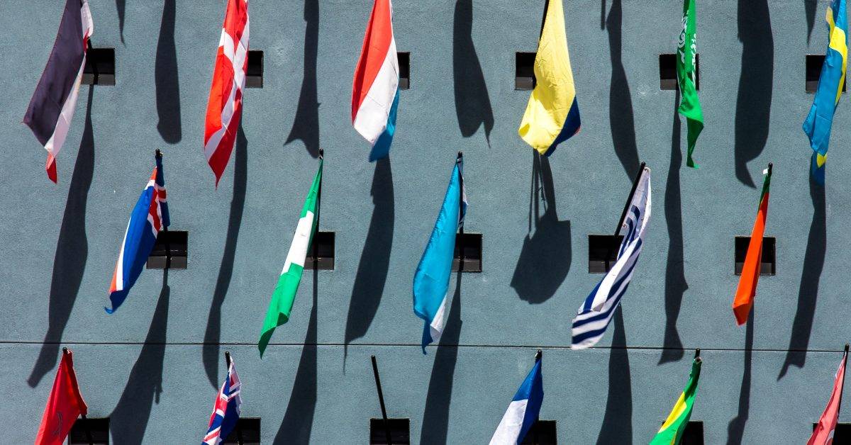 photo of assorted-color nation flags on wall during daytime