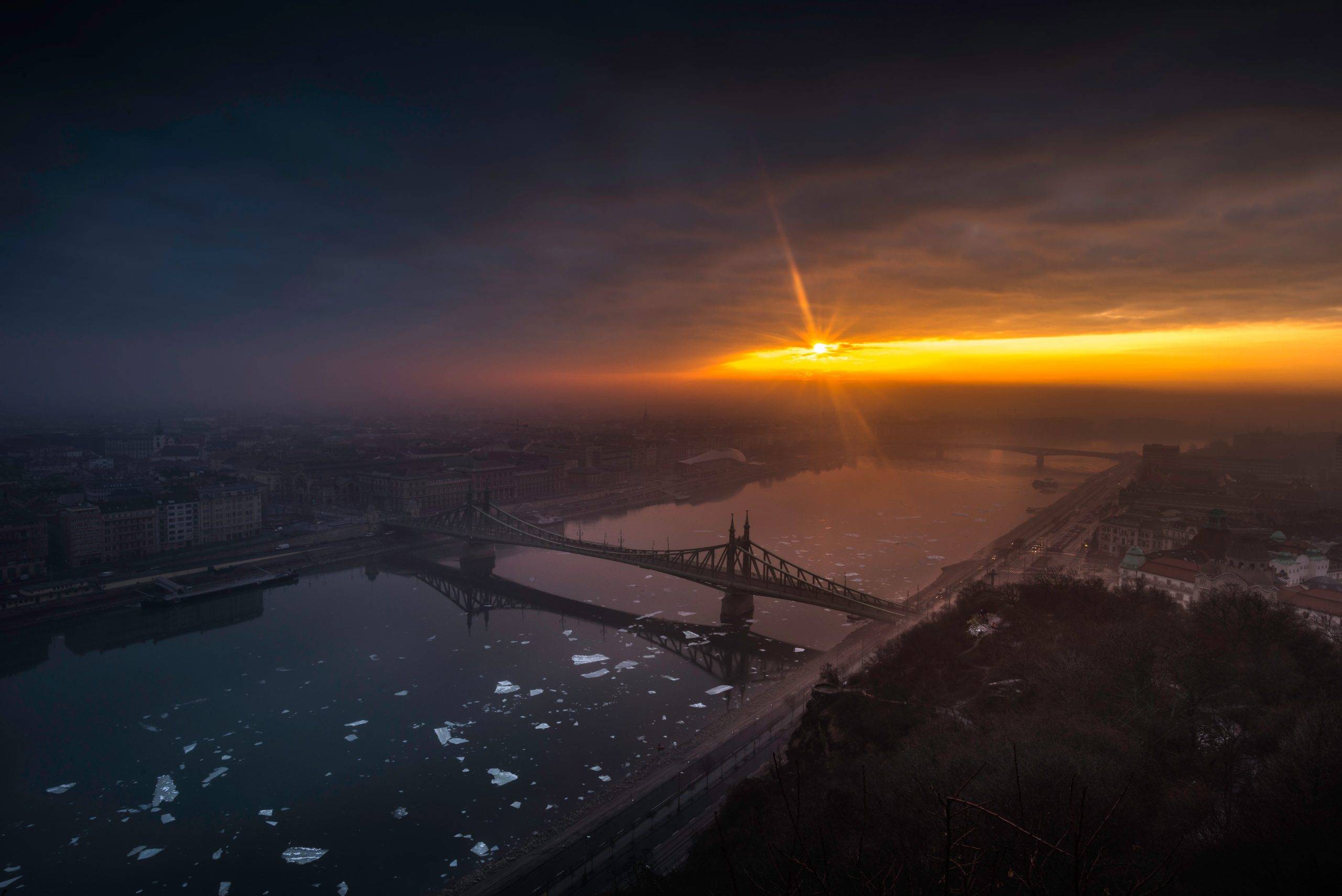 aerial photography of bridge on top of body of water at golden hour